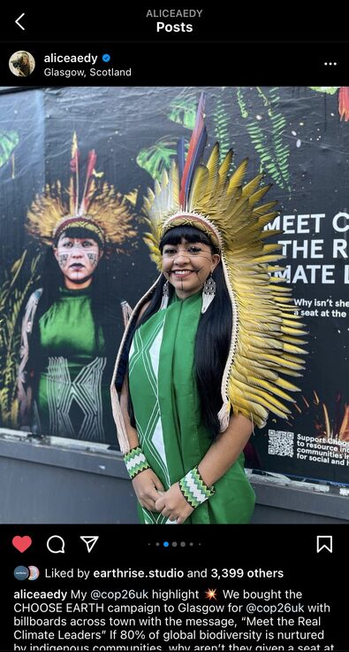 A screenshot of Alice Aedy's Instagram page featured a young Indigenous Amazonian woman wearing traditional clothes and smiling at the camera. The woman stands before a campaign poster bearing her likeness.
